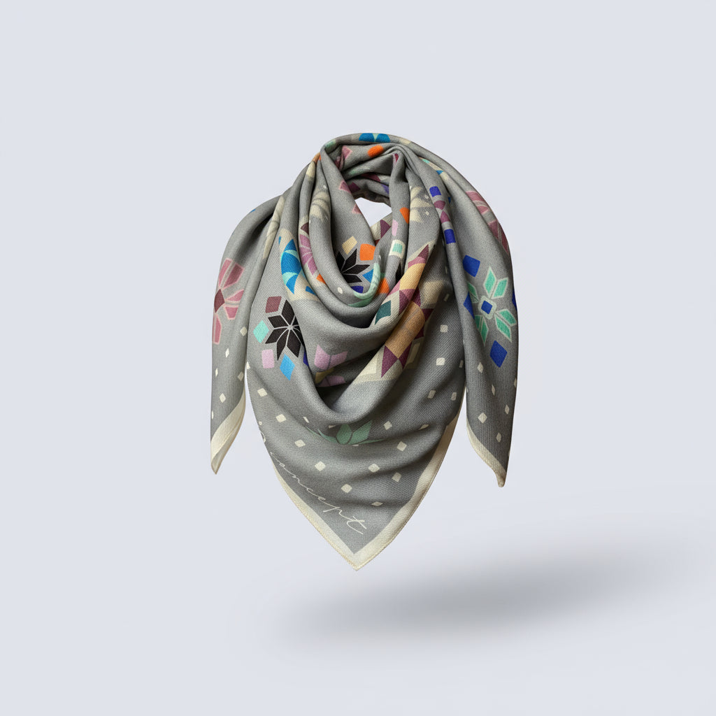 Gray scarf with colorful geometric pattern on a light gray background