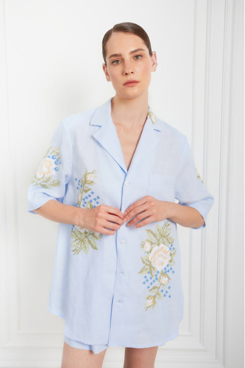 Light blue embroidered linen shirt with floral cross-stitch