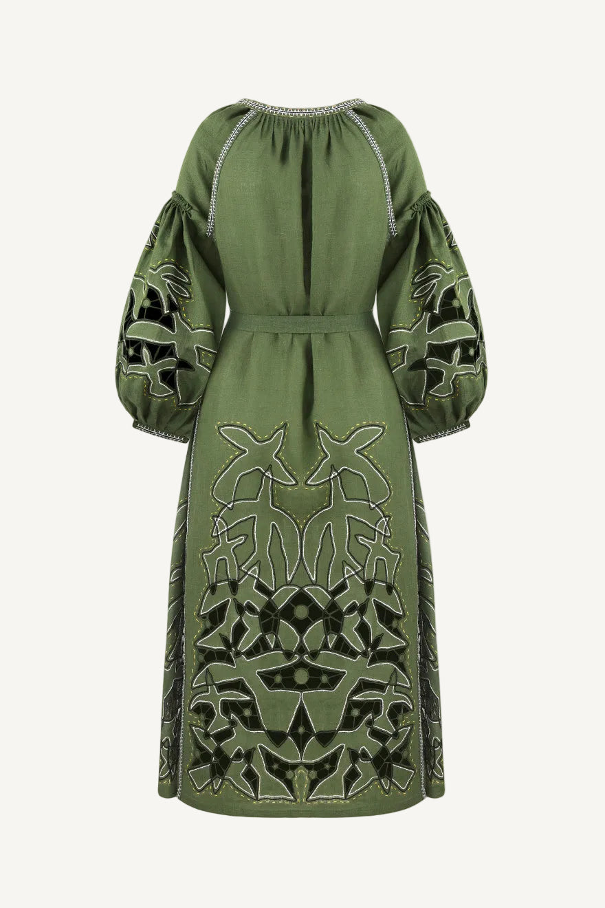 Green dress with intricate patterns on a white background