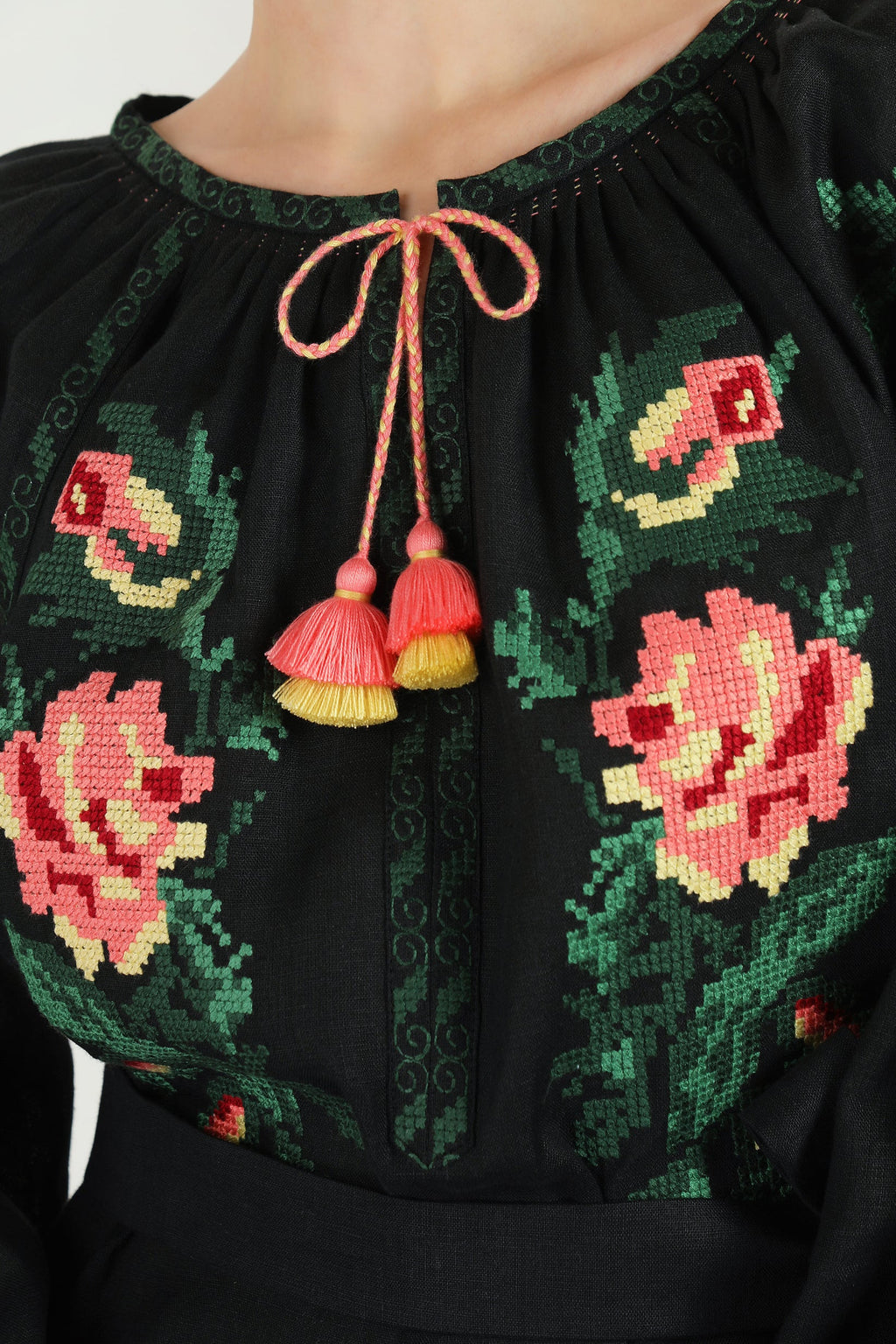 Black blouse with floral embroidery and colorful tassels