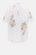White blouse with floral embroidery on a white background