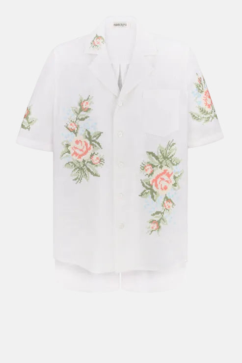 White blouse with floral embroidery on a white background