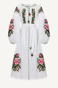 White dress with floral embroidery on a white background