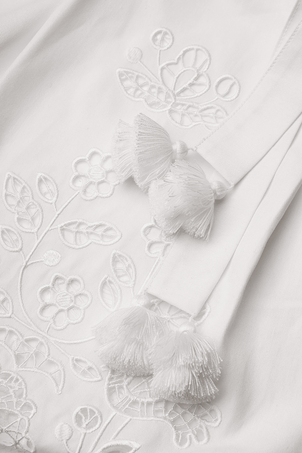 Model wearing the Foberini white linen Tree of Life pinafore apron dress