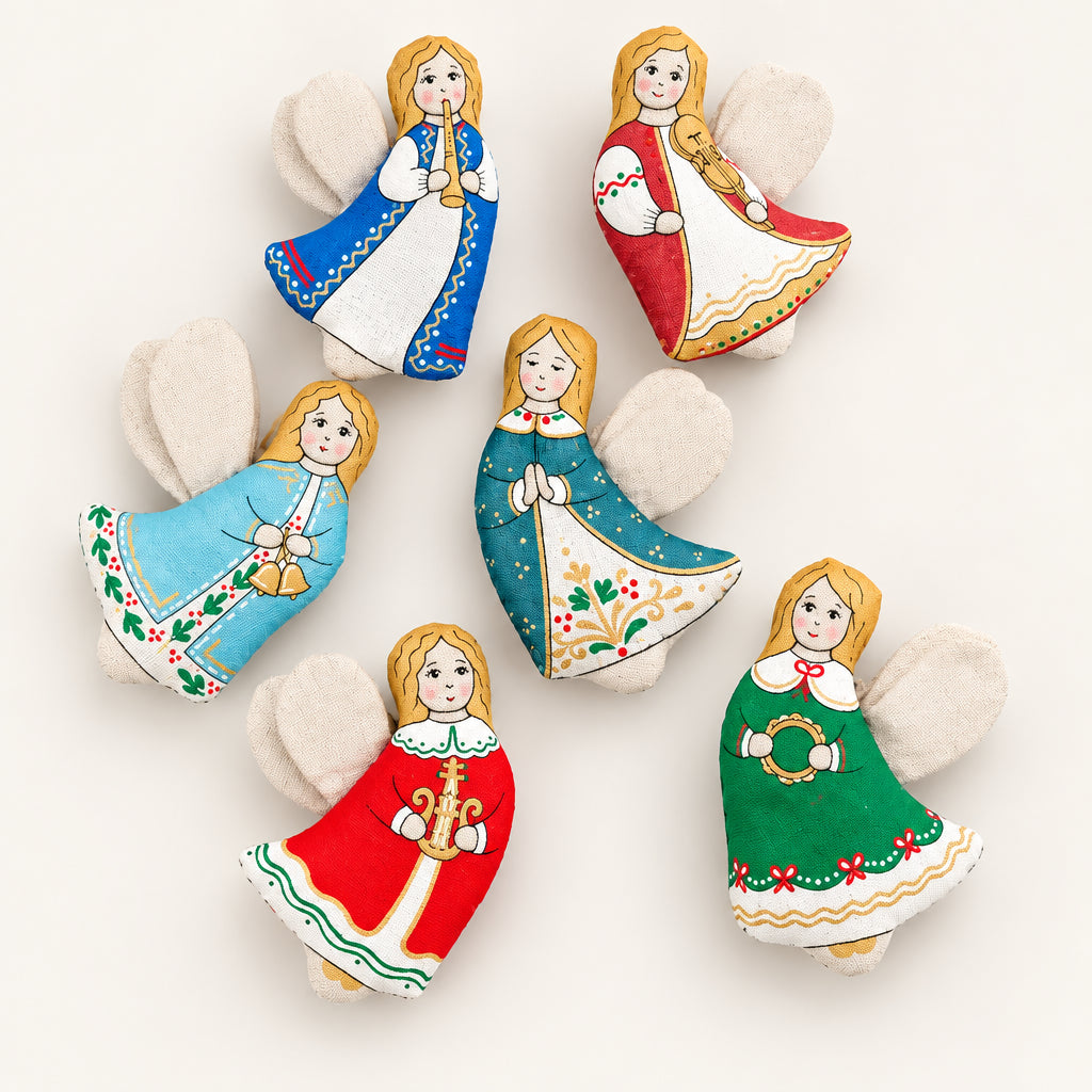 Six hand-painted wooden Christmas angels with wings, arranged on a textured brown background. Each angel has a different colored dress (blue, red, light blue, teal, red, green) and holds a musical instrument.