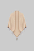 Beige poncho with tassels on a white background
