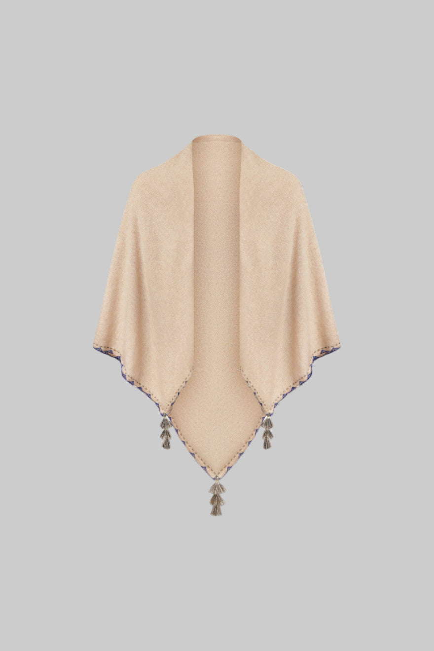 Beige poncho with tassels on a white background
