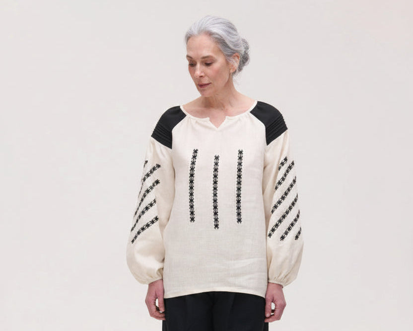 Handcrafted linen blouses with folk embroidery, puff sleeves and geometric 
motifs. Artisan-made in small batches. Slow fashion, locally made.