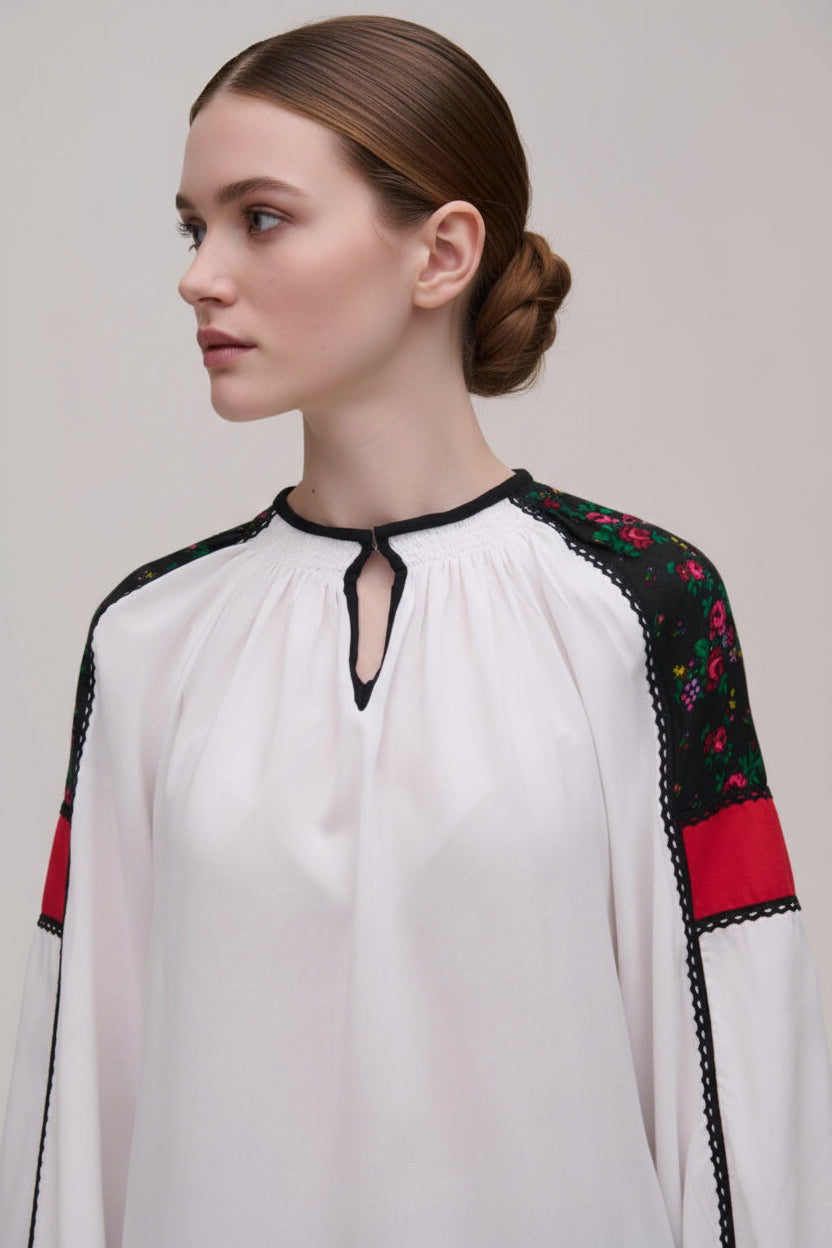 White blouse with traditional embroidered sleeves on 
