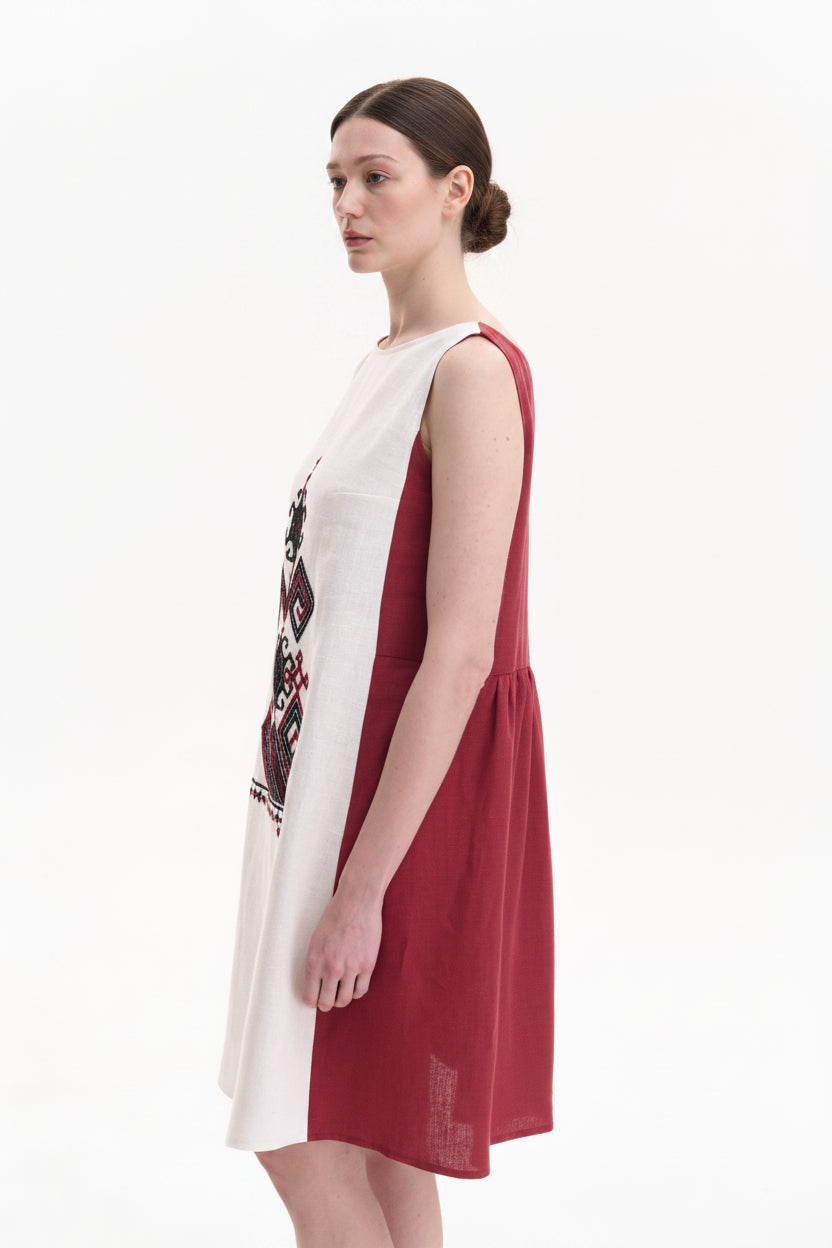 Woman wearing a white and red dress with floral design on a white background