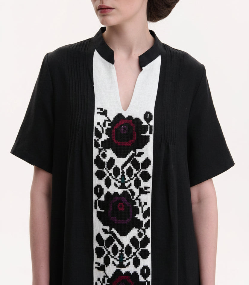 Black cardigan with floral pattern on a white background