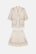 Beige embroidered jacket and shorts set on a white background