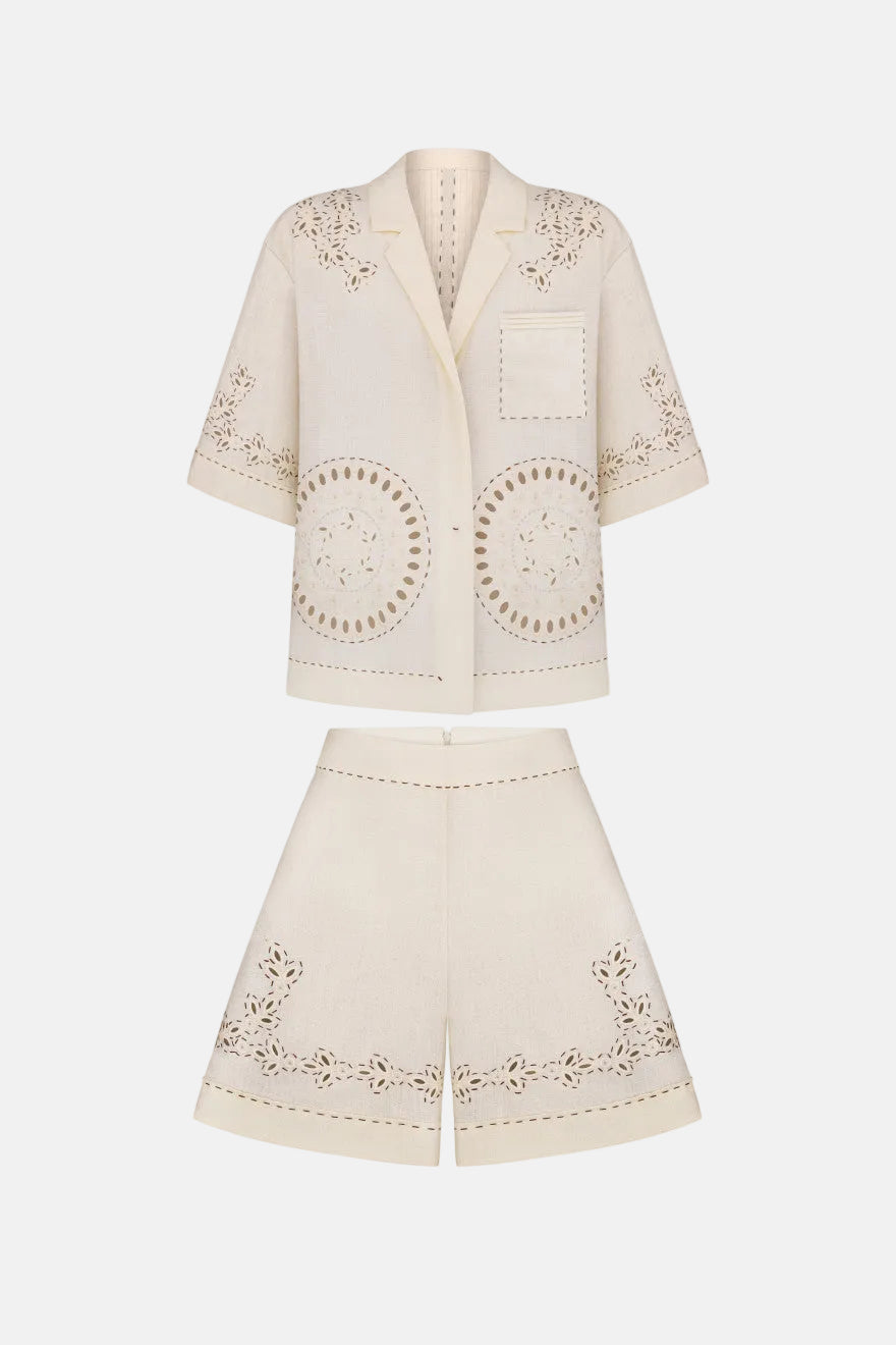 Beige embroidered jacket and shorts set on a white background