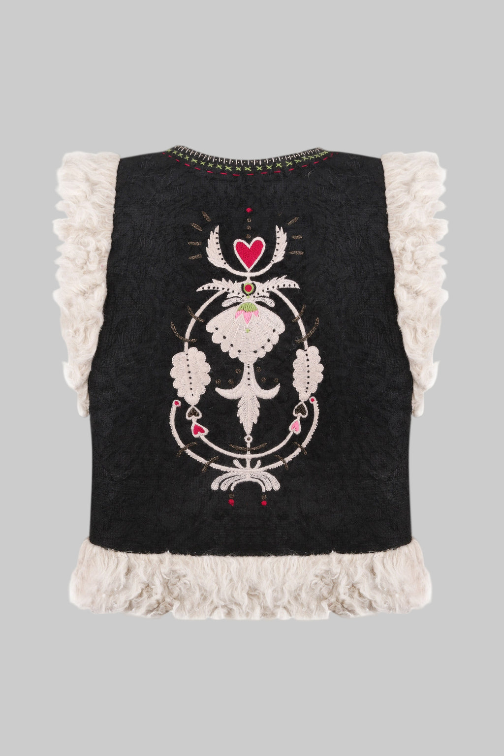 Black sleeveless top with white lace trim and decorative embroidery on a white background