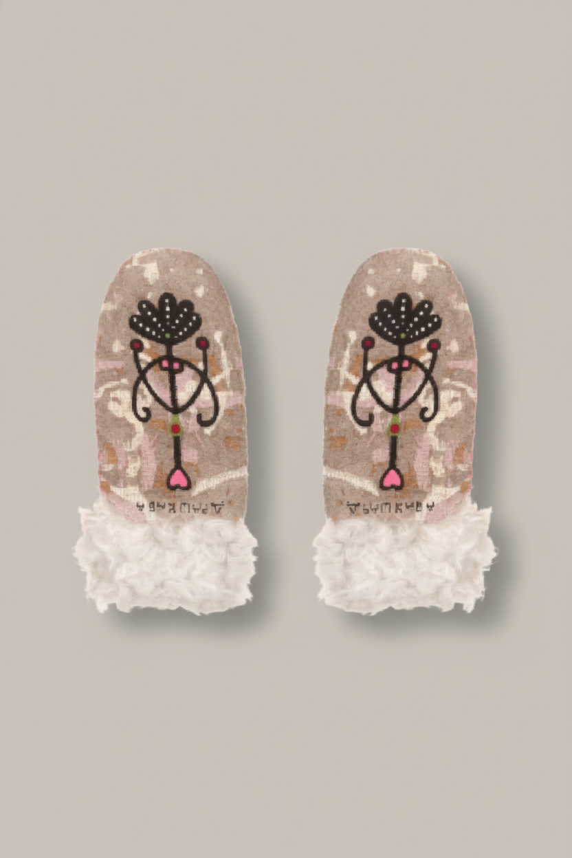 Pair of mittens with decorative design and lace cuffs on a white background