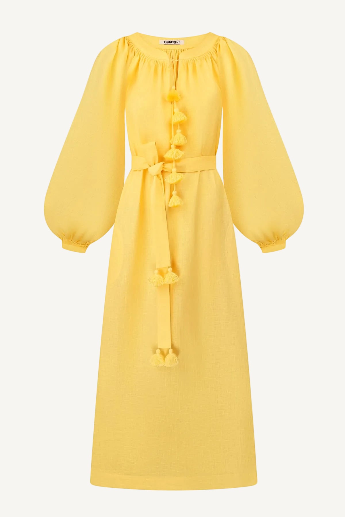 A bright yellow midi dress with long balloon sleeves, a gathered round neckline, and decorative tassel details down the front and at the waist, shown on a plain white background.