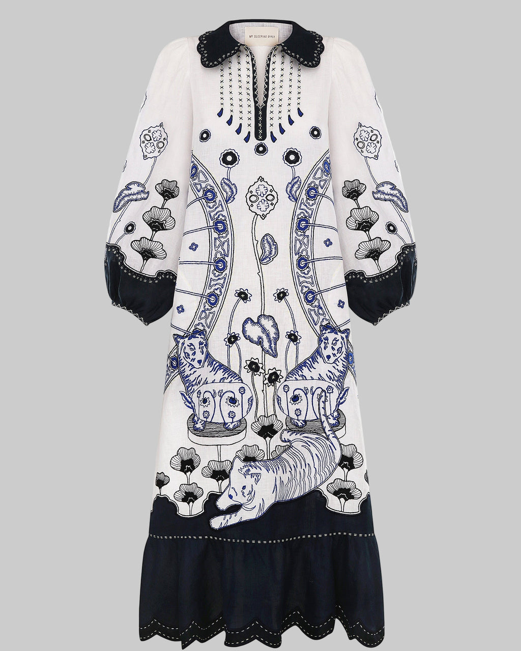 White dress with black and blue floral patterns on a white background