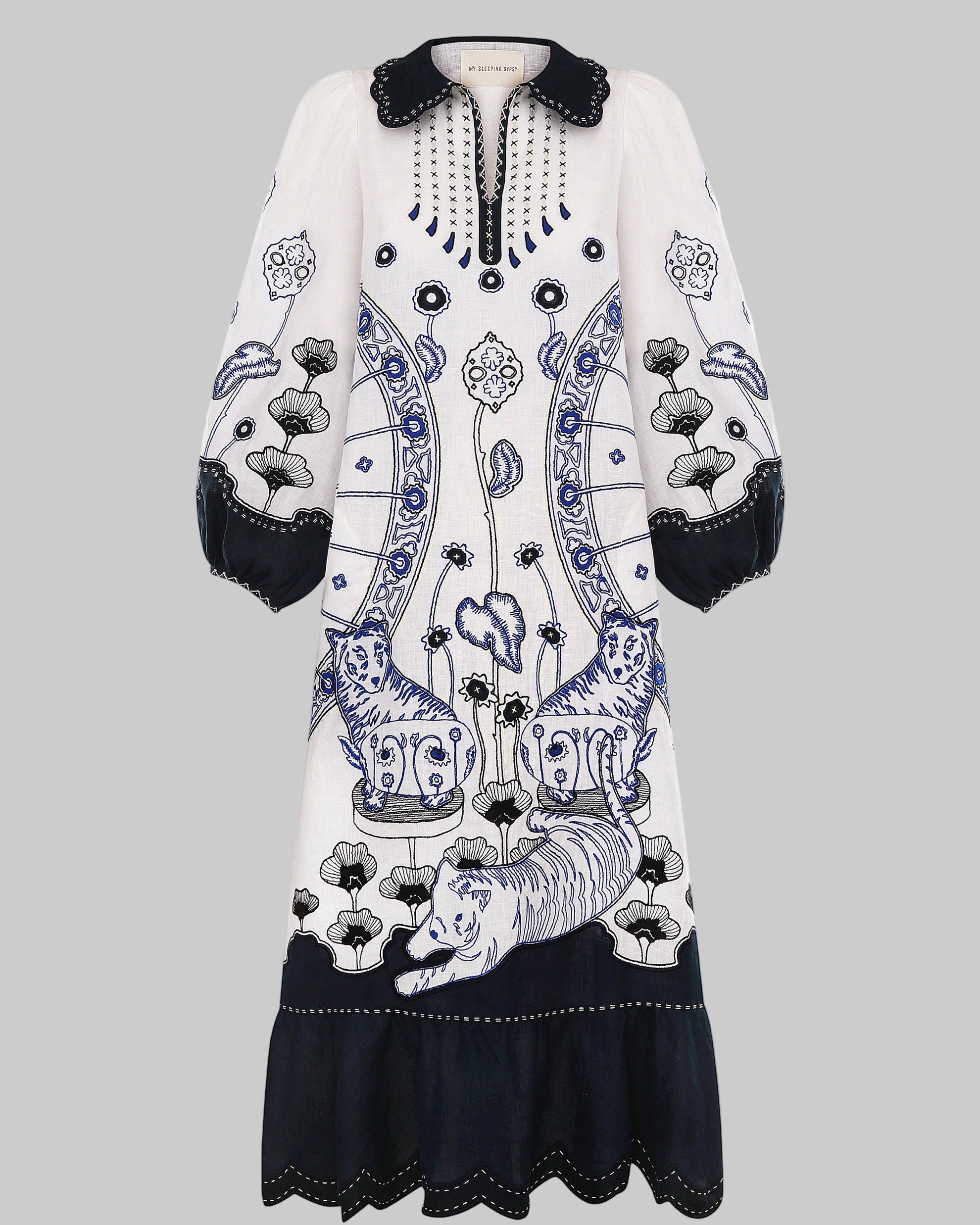 White dress with black and blue floral patterns on a white background